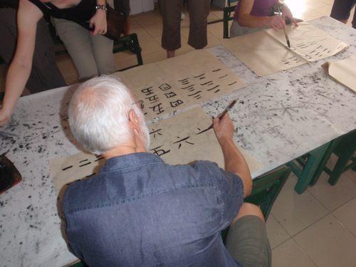 Sam is doing a good job of copying the Chinese characters.
